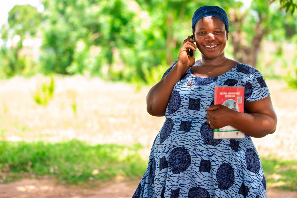 A pregnant woman receiving voice message through the Kpododo Mobile Messaging